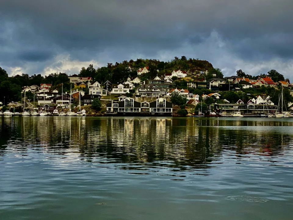 River and reflected hillside houses in Porsgrunn, Norway