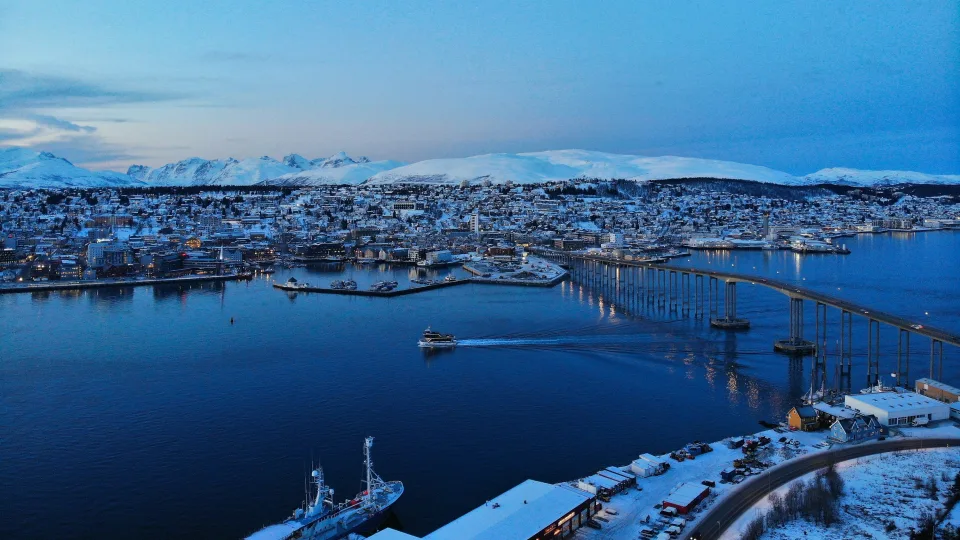 Snowy waterfront and bridge in Tromsø, Norway