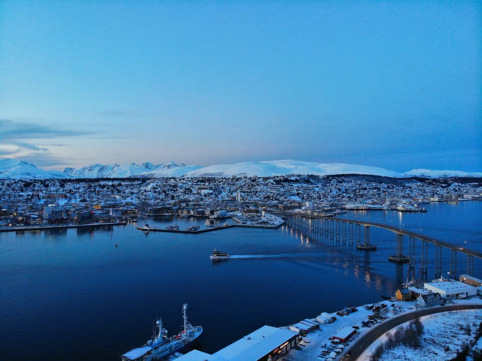 Snowy waterfront and bridge in Tromsø, Norway