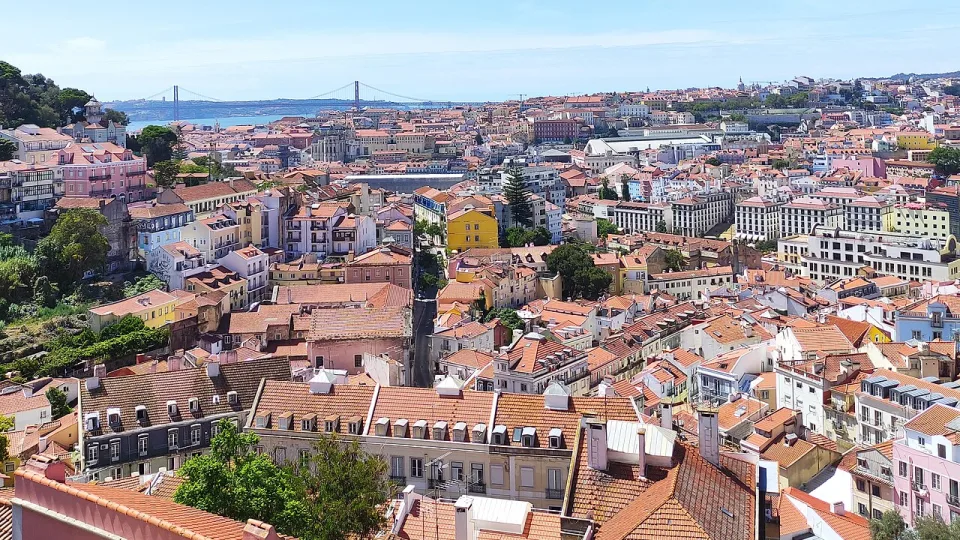 Lisbon rooftops, the Tagus and a distant bridge viewed from Miradouro da Graça