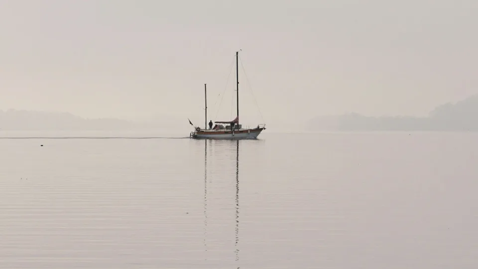 Regional view of a sailboat and its reflection on Lake Biel/Bienne, Switzerland