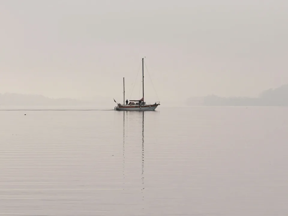 Regional view of a sailboat and its reflection on Lake Biel/Bienne, Switzerland