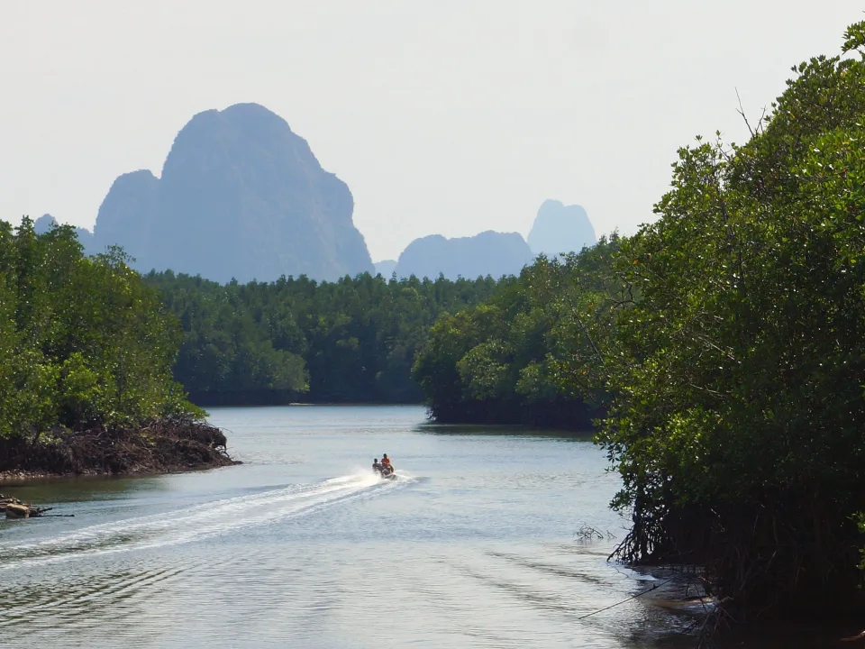 Boat and limestone hills in Phang Nga Bay, Thailand