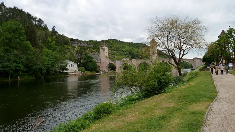 The Pont Valentré bridge and tree-lined River Lot in Cahors.