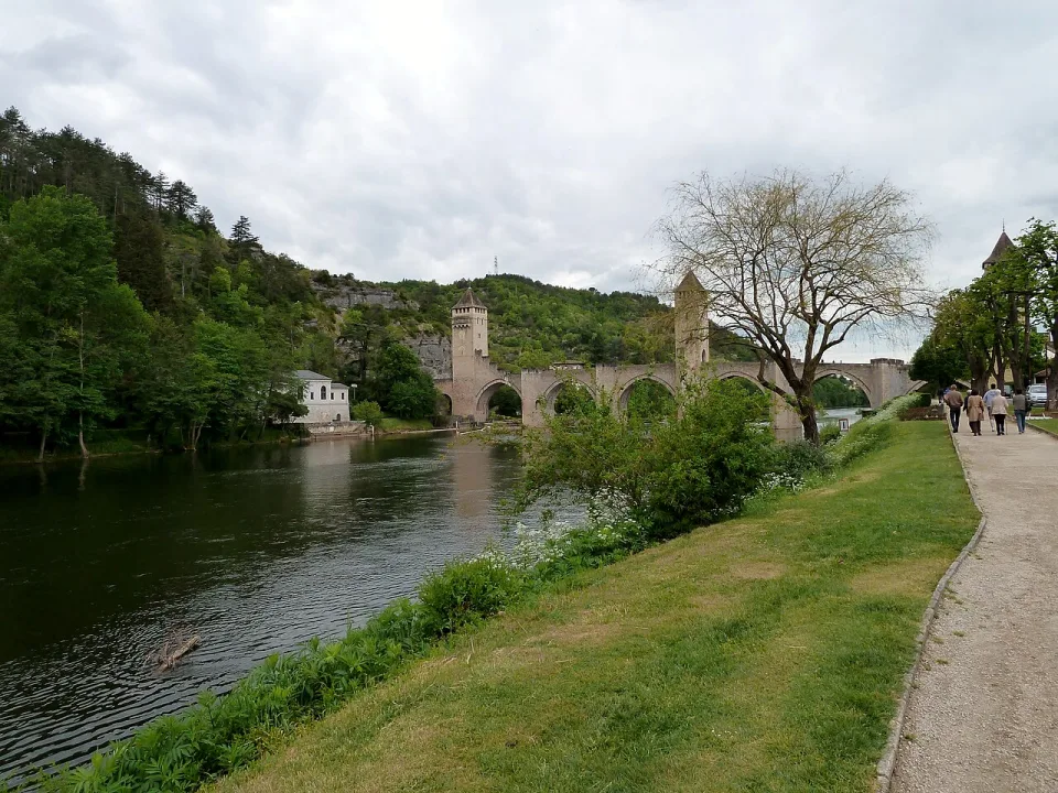 The Pont Valentré bridge and tree-lined River Lot in Cahors.