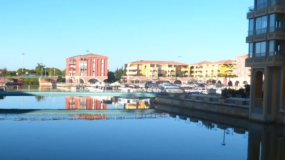 Waterside buildings and moored boats at Port Ariane in Lattes.