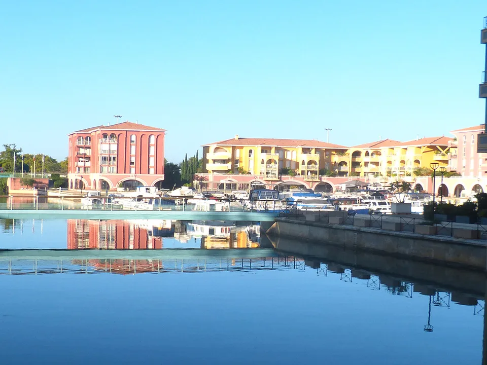 Waterside buildings and moored boats at Port Ariane in Lattes.