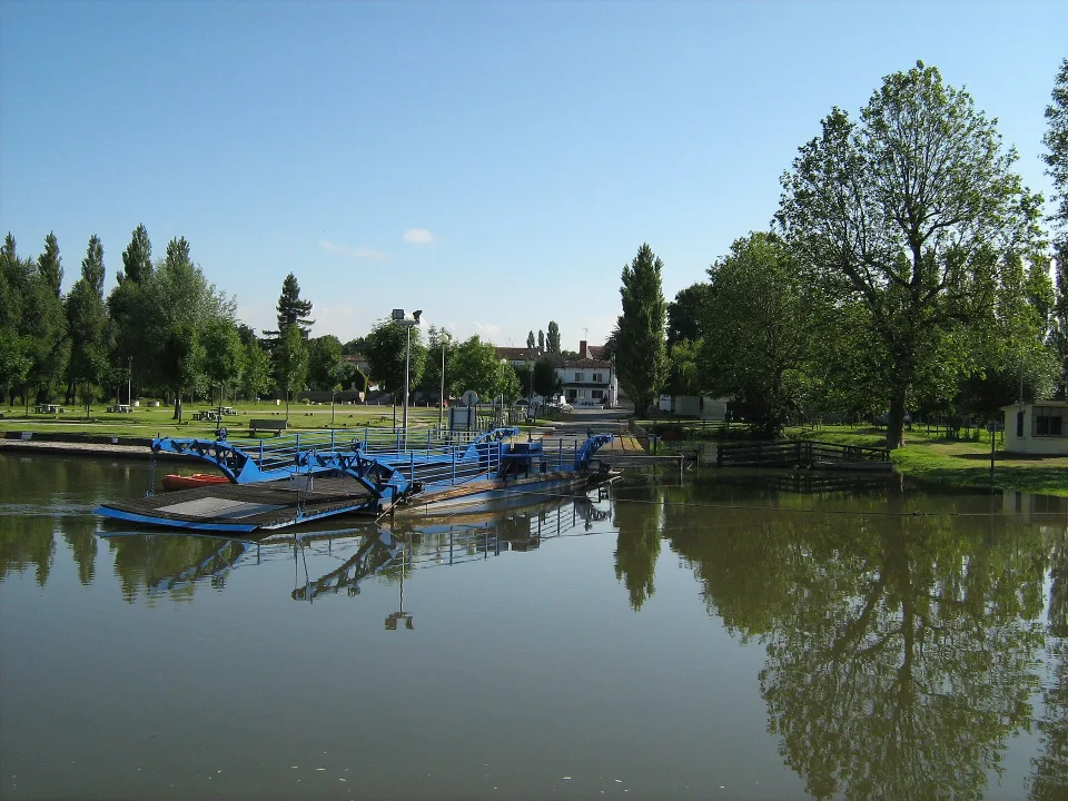 Regional Charente context: the ferry and tree-lined river at La Baine, near Chaniers.