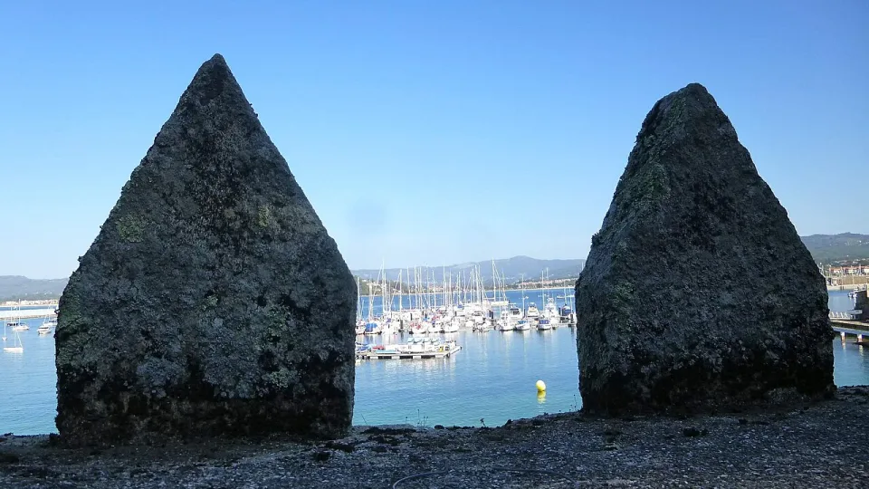 Baiona harbour seen through the walls of the waterfront fortress.