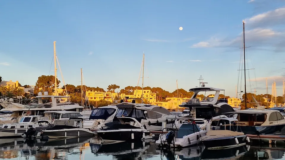 Yachts moored along the inlet at Cala d'Or marina, Mallorca.