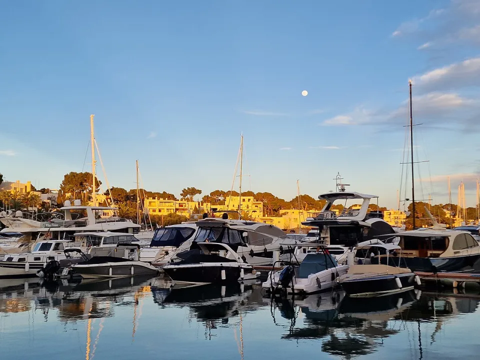 Yachts moored along the inlet at Cala d'Or marina, Mallorca.