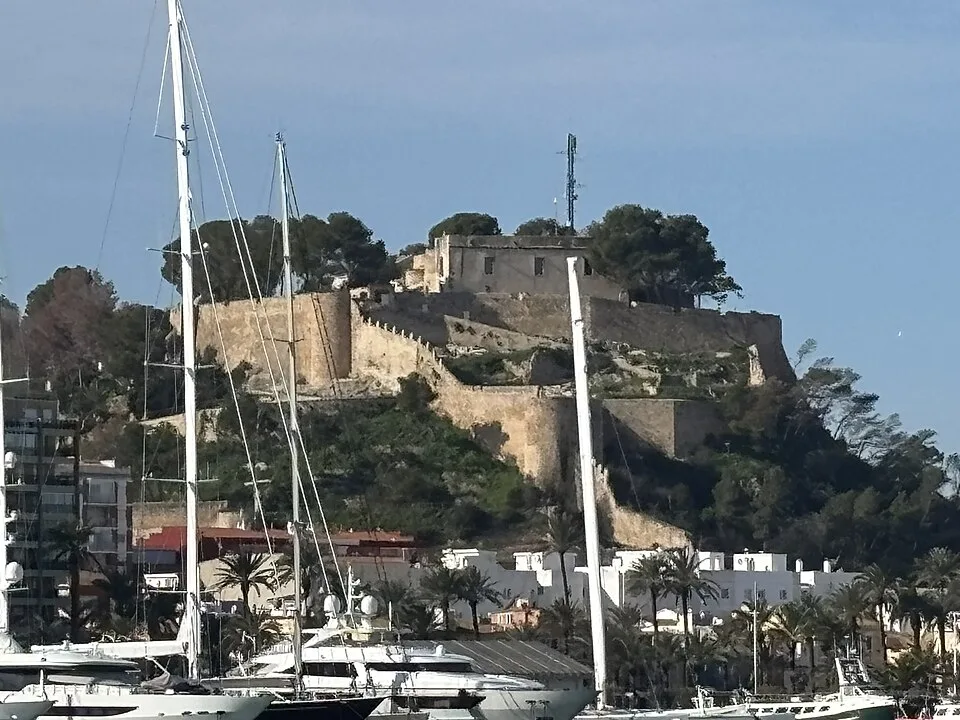 Sailing yachts below the castle overlooking the harbour in Dénia.