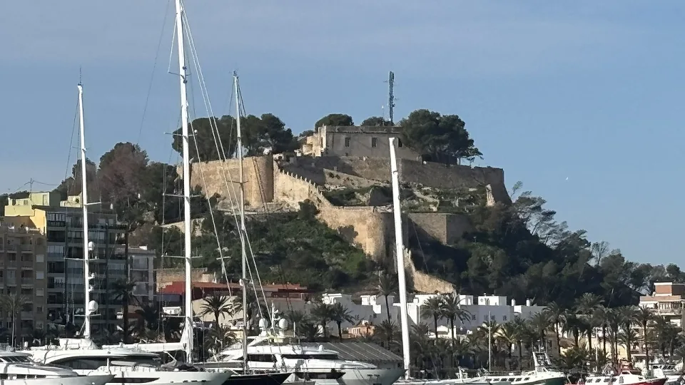 Sailing yachts below the castle overlooking the harbour in Dénia.