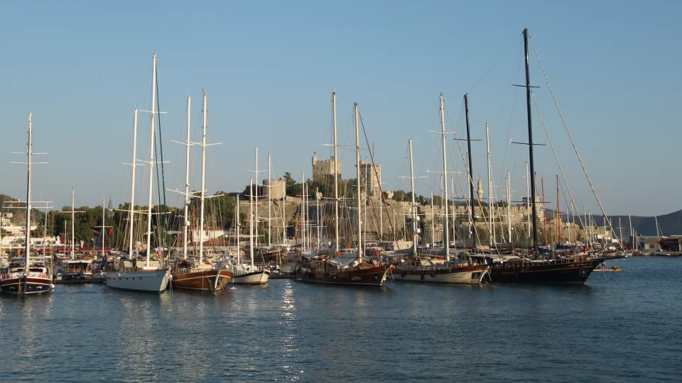 Wooden sailing vessels moored below Bodrum Castle.