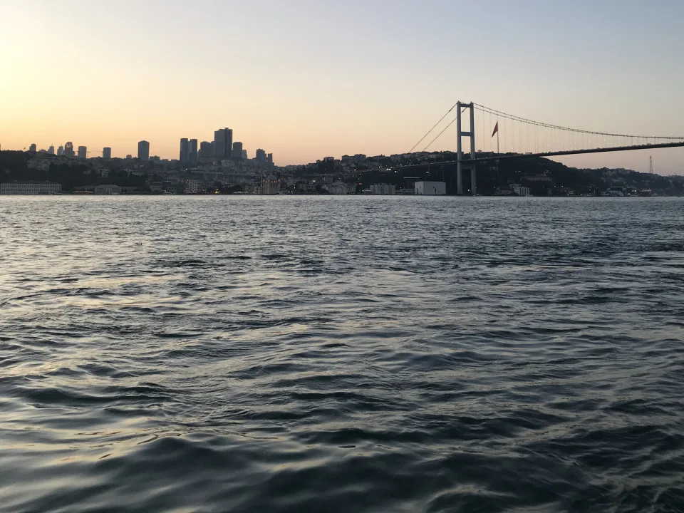An Istanbul bridge and waterside skyline seen across the Bosphorus.